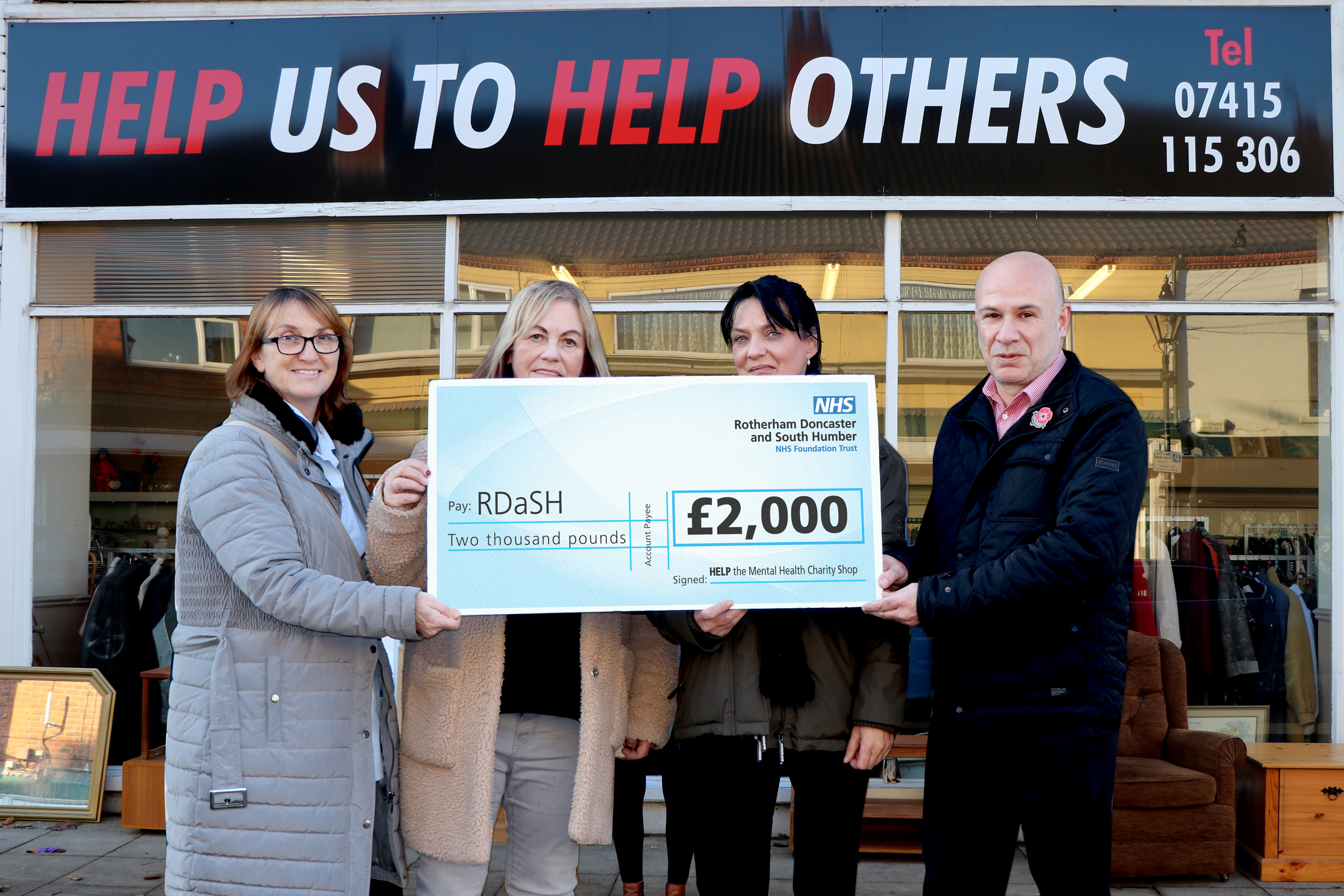 Volunteers and RDaSH staff are pictured with the cheque outside the charity shop